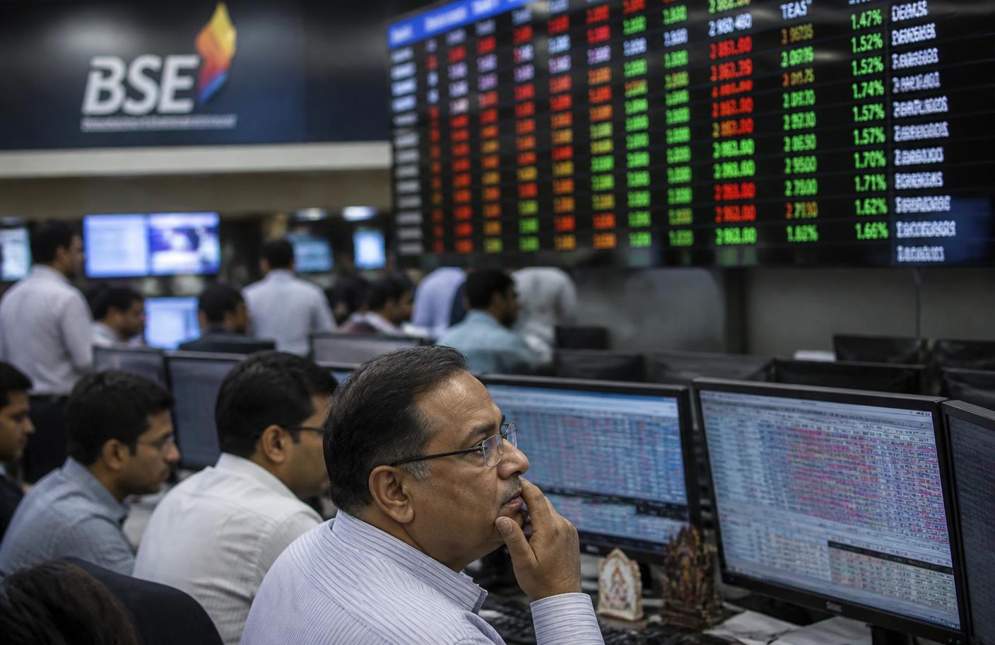 Analysts watching market data screens on a trading floor